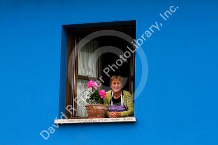 Spanish woman in the window of her home in the municipality of Cangas de Onis in Asturias, Spain. MR