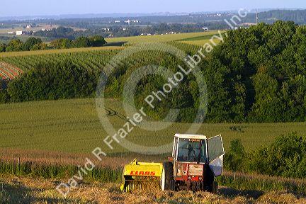 Tractor baling hay west of Angouleme in southwestern France.