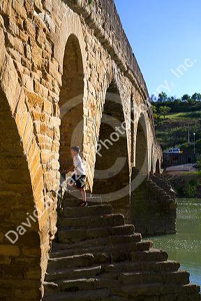 Six-arched Roman bridge spanning the Arga River on the Way of St. James pilgrimage route in Puente La Reina, Navarra, Spain.