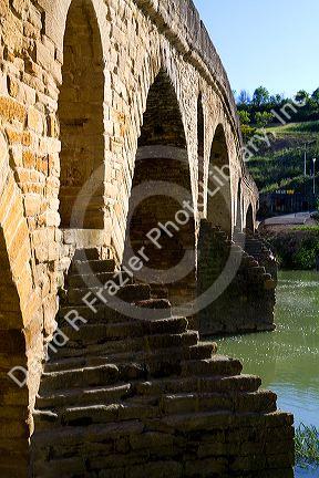 Six-arched Roman bridge spanning the Arga River on the Way of St. James pilgrimage route in Puente La Reina, Navarra, Spain.