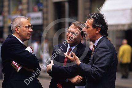 Italian businessmen talking on the street.