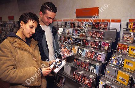 Young people shopping for CD's in an Italian music store.