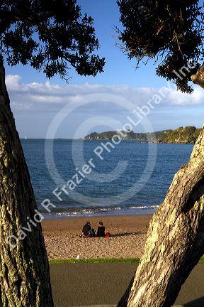 People on the beach at Bay of Islands at the town of Paihia, North Island, New Zealand.