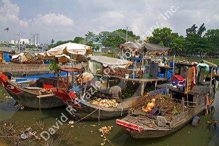 Boats and lifestyle along a canal in Ho Chi Minh City, Vietnam.