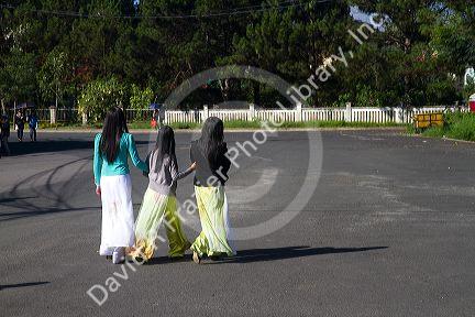 Vietnamese students walking in traditional dress in Da Lat, Vietnam.