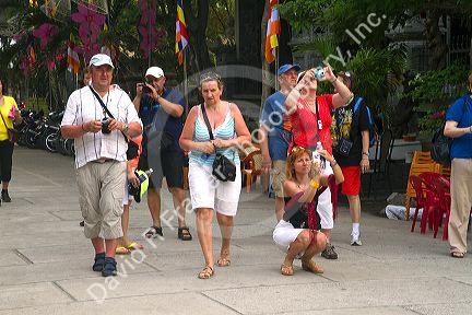 Russian tourists using cameras in Nha Trang, Vietnam.