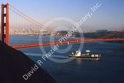 A cargo ship passes under the Golden Gate Bridge in San Francisco, California.