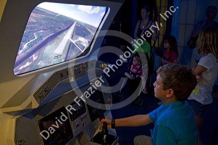 Boy using a flight simulator at the John F. Kennedy Space Center, Merritt Island, Florida, USA.