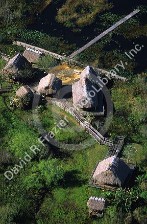 An aerial of a Seminole Miccosukee Indian village with chopekcheke traditional dwellings.