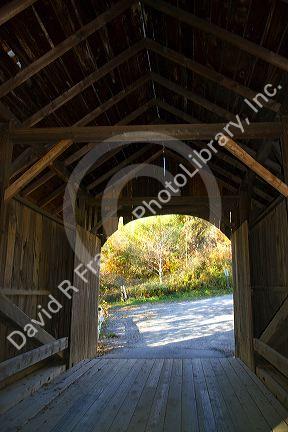The Mill Covered Bridge crossing the Lamoille River in Belvidere, Vermont, USA.