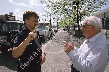 A policeman using sign language with a deaf man.
