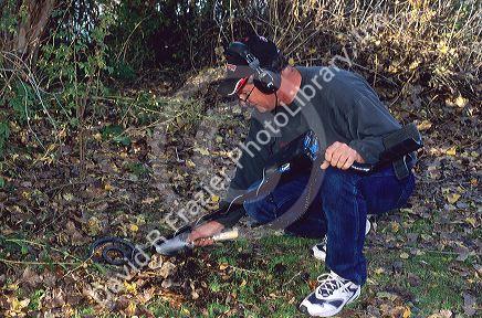 Man using a metal detector.