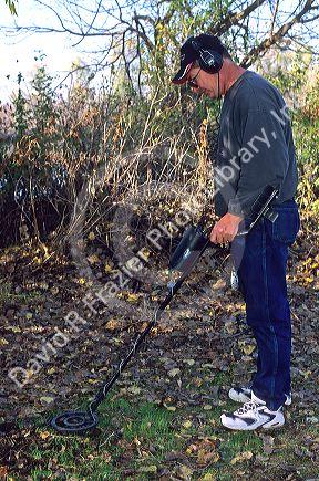 Man using a metal detector.