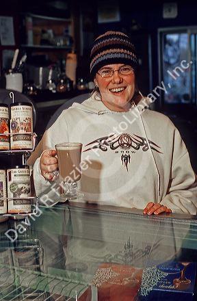A female employee making coffee drinks at a coffee shop in Boise, Idaho.