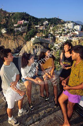 Mexican teens talk in Acapulco, Mexico.
