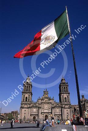 The national flag of mexico stands in front of the Catedrale Metropolitana in Mexico City, Mexico.