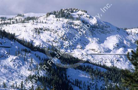 Donner pass in California in winter.  The horizontal line is the so-called snow shed which keeps the snow off the rainroal tracks.
