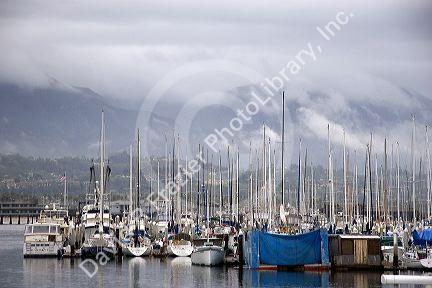 Rain clouds and foggy mist over the mountains at Santa Barbara, California with the marina in the foreground.