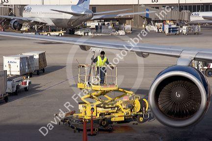 Ground crew refueling an airplane at Salt Lake City International Airport, Utah.