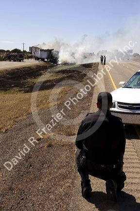 An automobile accident on Interstate 40 east of Moriarty, New Mexico with a state trooper investigating.