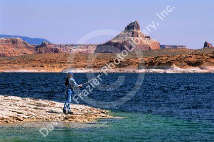 A woman fisherman using a spinning reel at Lake Powell in Southern Utah.