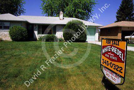 Real estate sign showing a home is for sale.