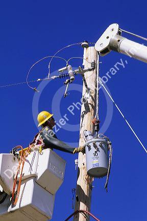 A power lineman wearing protective gear.