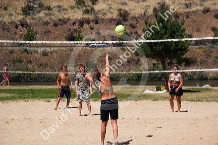 Teens playing beach volleyball at Sandy Point near Boise, Idaho.