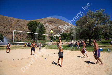 Teens and adults playing beach volleyball at Sandy Point near Boise, Idaho.