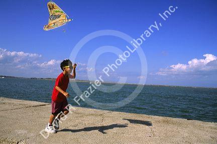 A boy flying a kite on the Texas Gulf Coast.