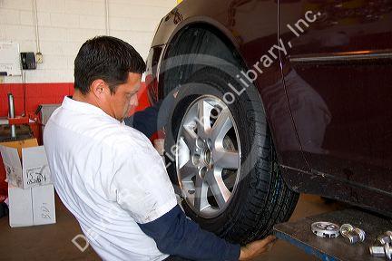 Installing tire on automobile.