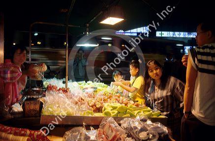 People shop at a night market in Taipei, Taiwan.