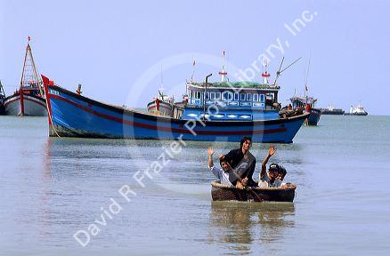 Fisherman riding in a wicker basket boat, Vung Tau, Vietnam.