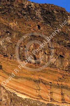 Horizontal rock stratification in basalt cliff.