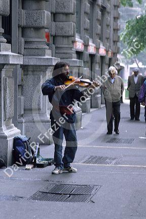 A street performer plays the violin in Milan, Italy.