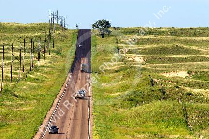 Automobiles travel on US-83 a two lane country road south of North Platte, Nebraska.