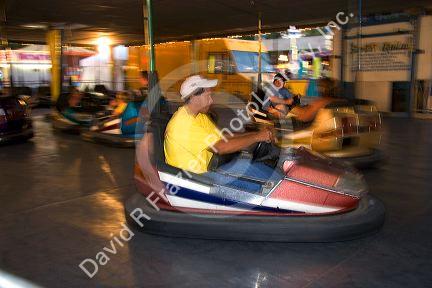 Children and adults ride bumper cars at the Iowa state fair in Des Moines.