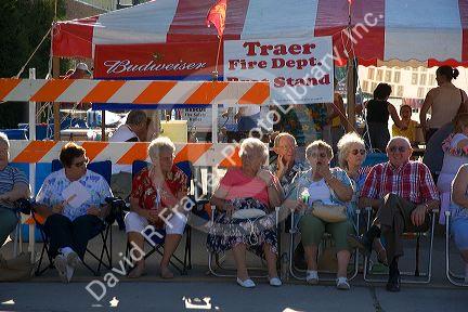 Residents of Traer, Iowa watch a parade for the Festival of the Spiral Steps.