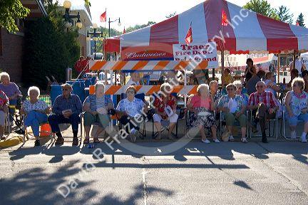 Residents of Traer, Iowa watch a parade for the Festival of the Spiral Steps.