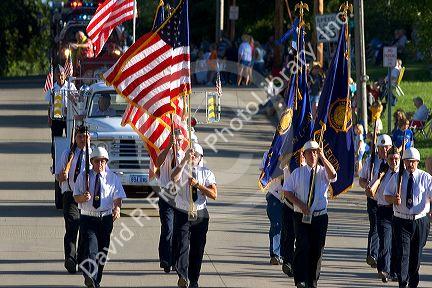 Veterans of Traer, Iowa march as honor guard in a parade for the Festival of the Spiral Steps.