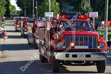 Firemen of Traer, Iowa parade their trucks in the Festival of the Spiral Steps.