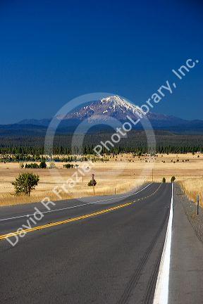 The highway near McArthur, California with a view of Mount Shasta in the background.