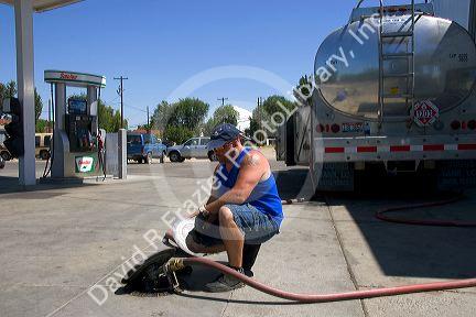 A man delivering gasoline to a station in Payette, Idaho.