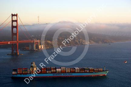 A container ship passes under the Golden Gate Bridge in the San Francisco Bay, California.