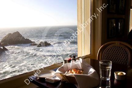A view of the ocean and a basket of sourdough bread at The Cliff House Restaurant on the San Francisco Coast, California.