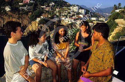 Mexican teens talking in a group at Acapulco, Mexico.