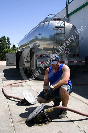 A man delivering gasoline to a station in Payette, Idaho.