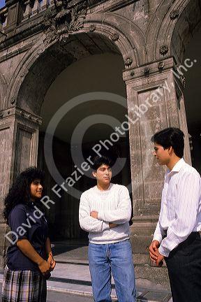 Mexican students talking in front of a building in Mexico City, Mexico.