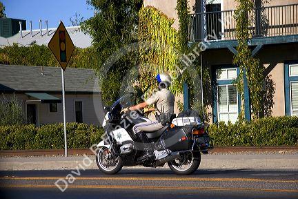 California Highway Patrol officer riding a motorcycle.