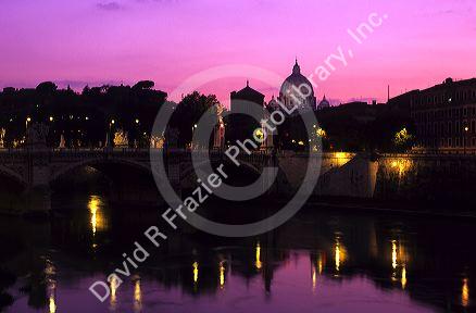 The Tiber River and St. Peters Basilica at The Vatican at sunset in Rome, Italy.